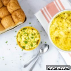 Instant Pot No-Peel Egg Salad 2 Overhead view of prepared egg salad garnished with chopped parsley and whole wheat bread to the side