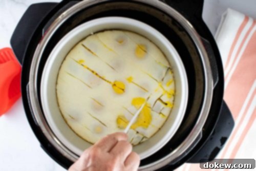 Instant Pot No-Peel Egg Salad 3 Overhead view of a layer of cooked eggs in an inner pot in an Instant Pot being cut into squares