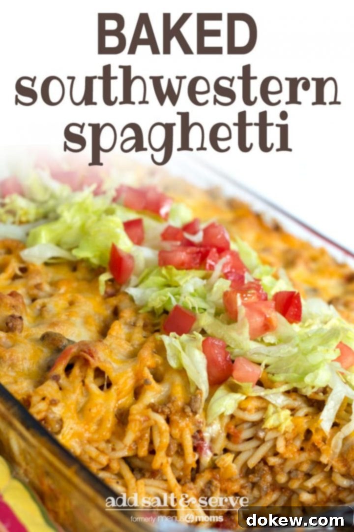 Baked Southwestern Spaghetti Clear casserole dish with spaghetti noodles, ground beef, and melted cheese, topped with shredded lettuce and diced tomatoes. Text baked southwestern spaghetti add salt & serve formerly menus4moms