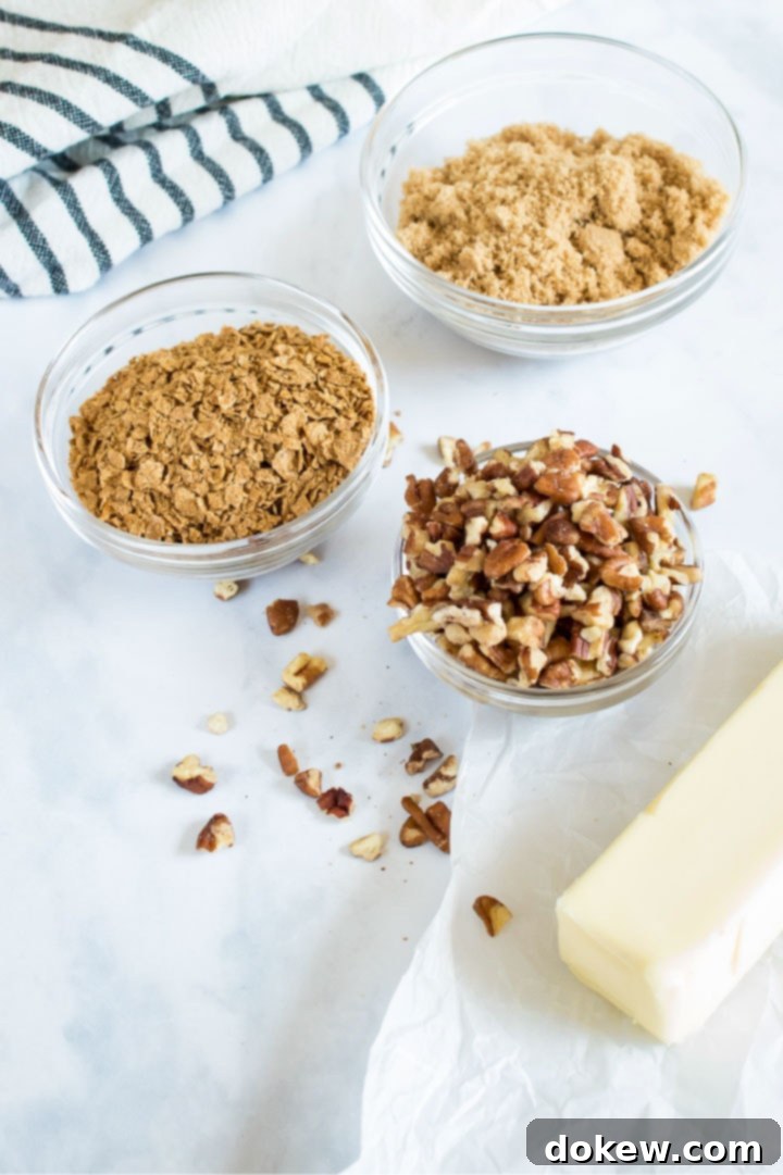 sweet-potato-casserole-ip-1-min Streusel topping ingredients laid out: melted butter, rich brown sugar, finely chopped pecans, and a bowl of crushed cereal