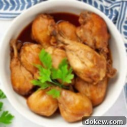 Cooked chicken legs in a serving dish garnished with parsley.