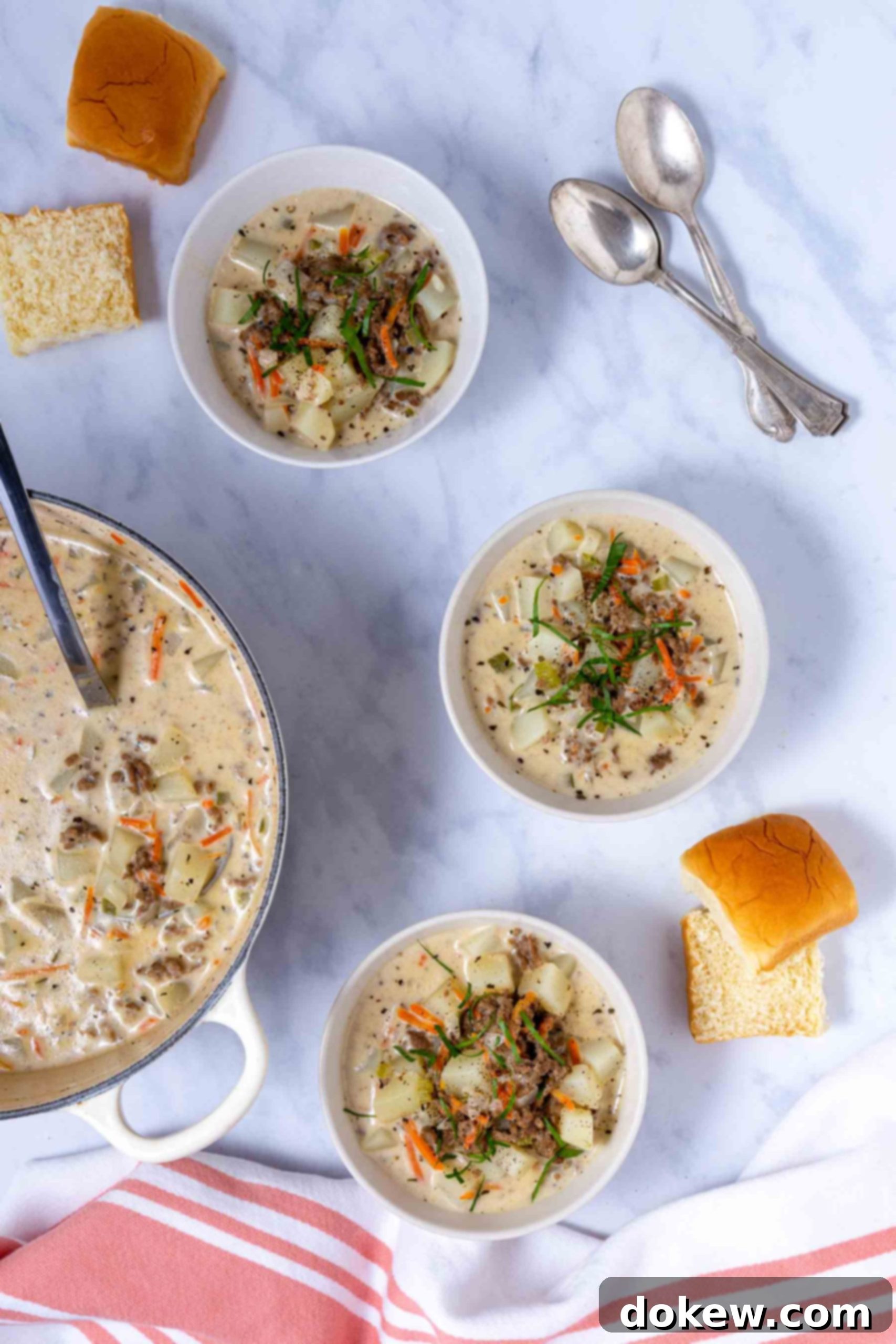 Rich & Creamy Velveeta Cheeseburger Soup 6 Three perfectly presented bowls of creamy Cheeseburger Soup with Velveeta, garnished with fresh herbs, resting next to a full pot of the soup.