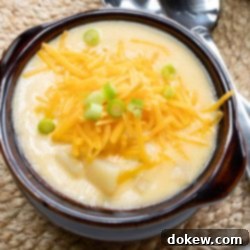 30-Minute Hash Brown Potato Soup 9 Potato soup with hash browns in a bowl and garnished with shredded cheddar cheese and sliced green onions.