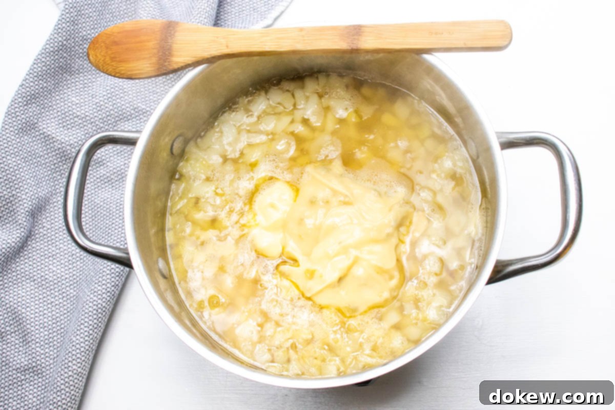 30-Minute Hash Brown Potato Soup 4 Potato soup after adding cream soups and evaporated milk to the broth, onions, and hash browns.