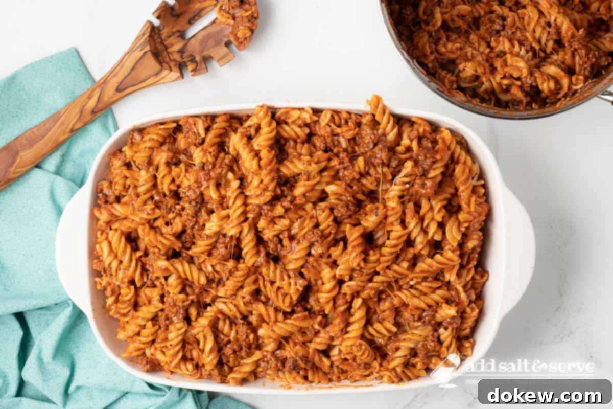 Creamy Cheesy Spirals 7 Spiral pasta bake in a white casserole dish before baking.