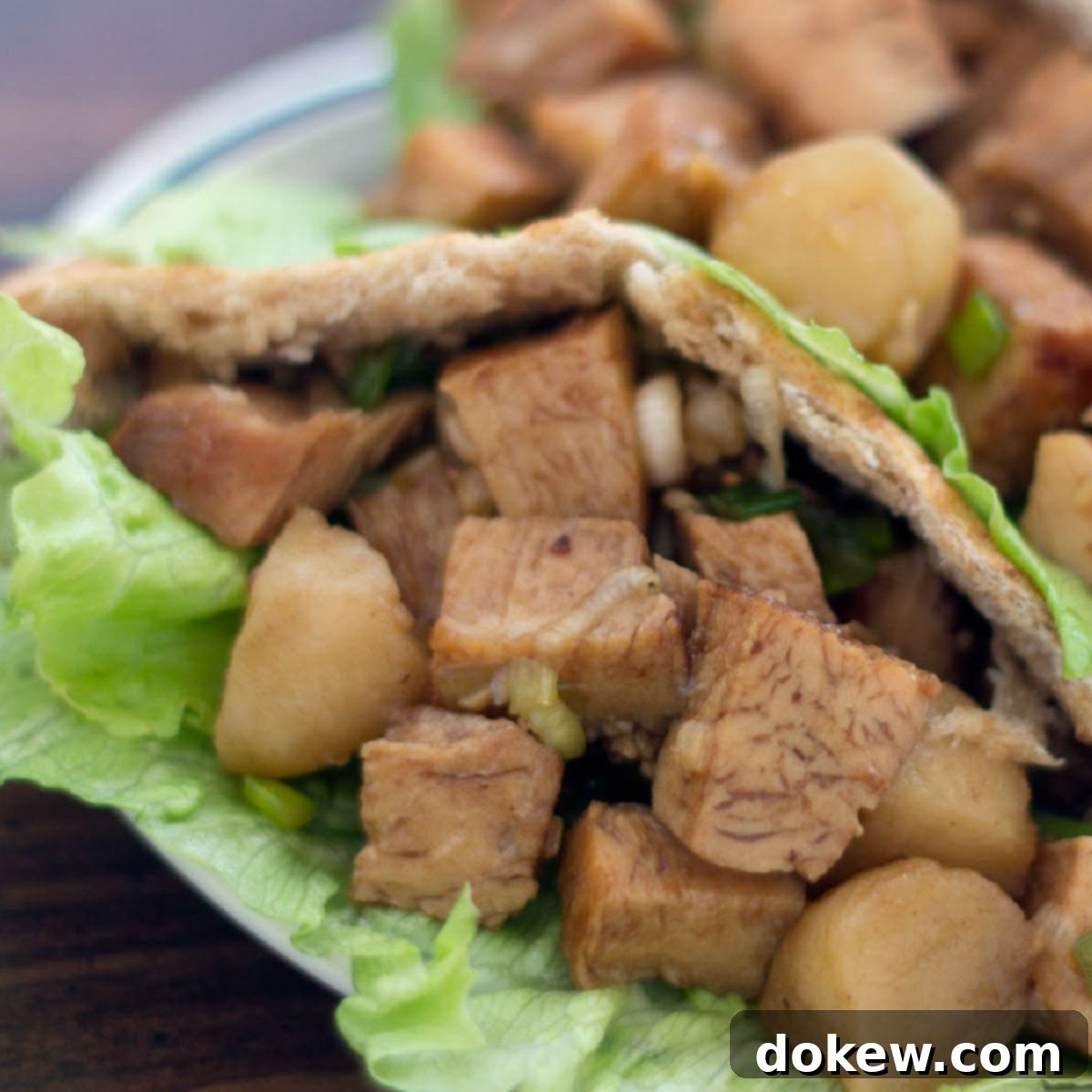 Umami Chicken Pita Parcels 2 Diced chicken in a lettuce-lined pita on a white plate