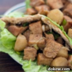 Umami Chicken Pita Parcels 3 Diced chicken in a lettuce-lined pita on a white plate