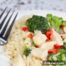 Velvety Chicken and Broccoli Ramen 3 A plate with Creamy Chicken and Broccoli Ramen and a fork, ready to be enjoyed.