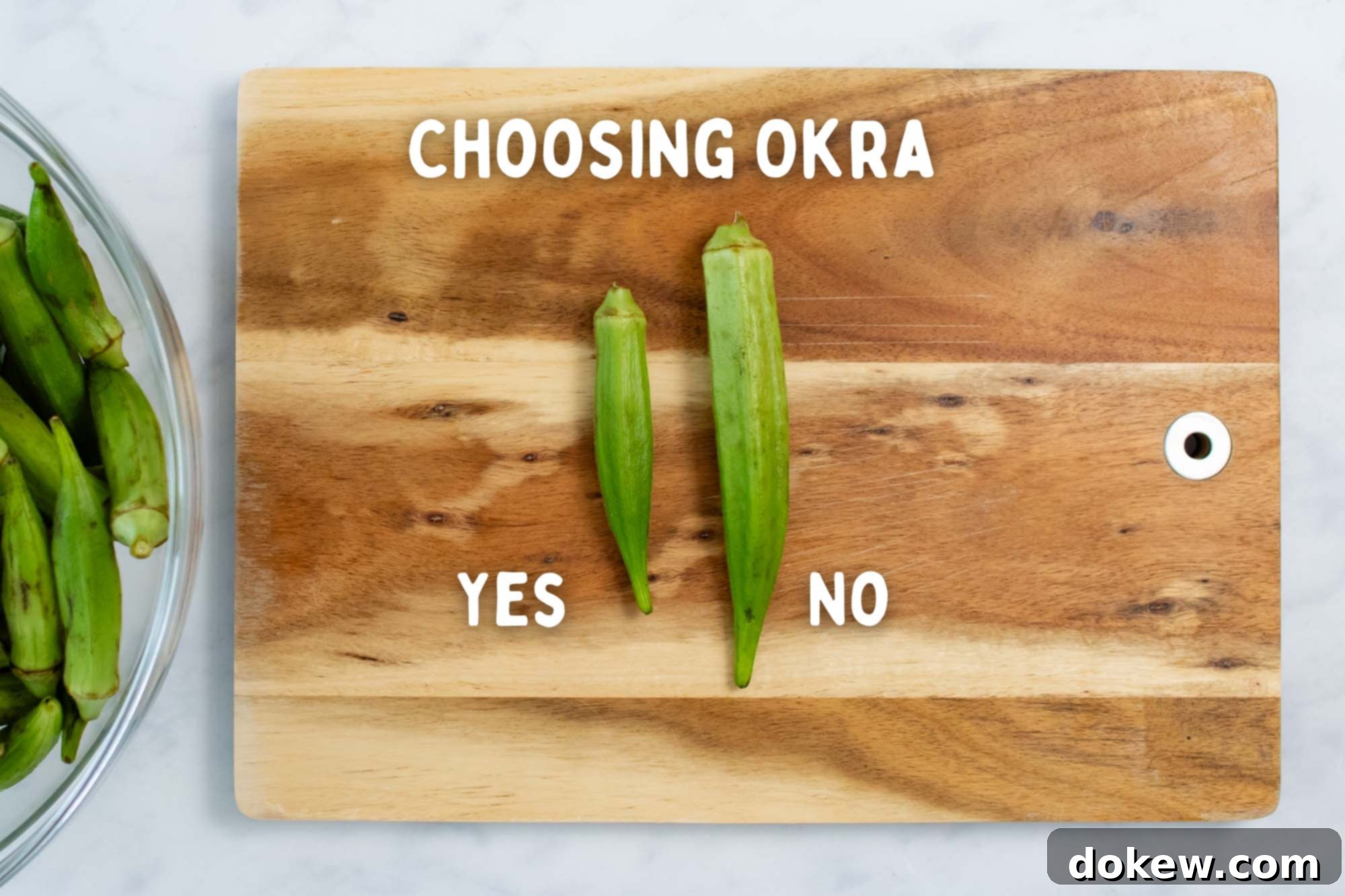 Effortless Sheet Pan Roasted Okra and Onions 5 A helpful visual guide for choosing okra, featuring a small, slender, and ideal okra pod clearly labeled 'Yes' alongside a much larger, thicker pod labeled 'No' on a rustic wooden cutting board, emphasizing the best choice for cooking.