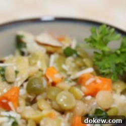 Sun-Kissed Mediterranean Mix 2 Lentils, carrots, artichokes, and almonds in a bowl topped with dressing and shredded parmesan cheese, garnished with parsley