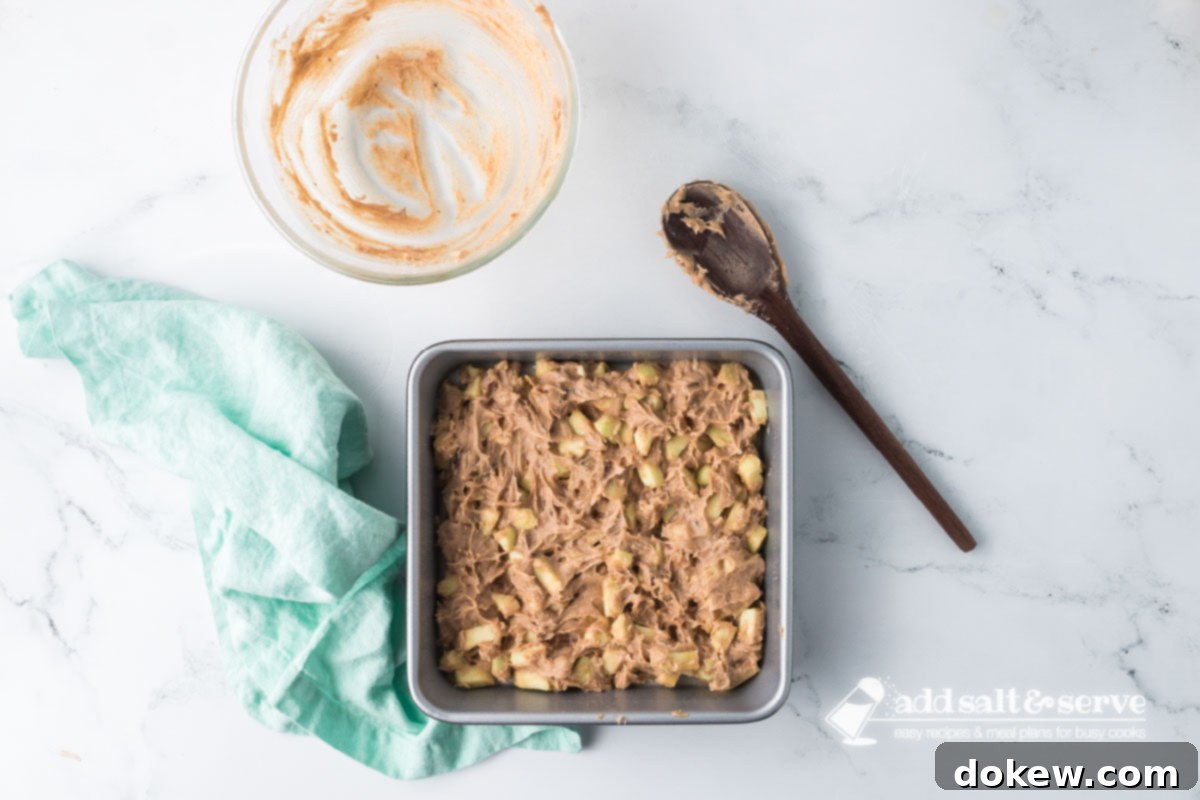 Spiced Apple Walnut Bars 8 Apple Walnut Bar batter spread in a prepared 9-inch by 9-inch baking pan.