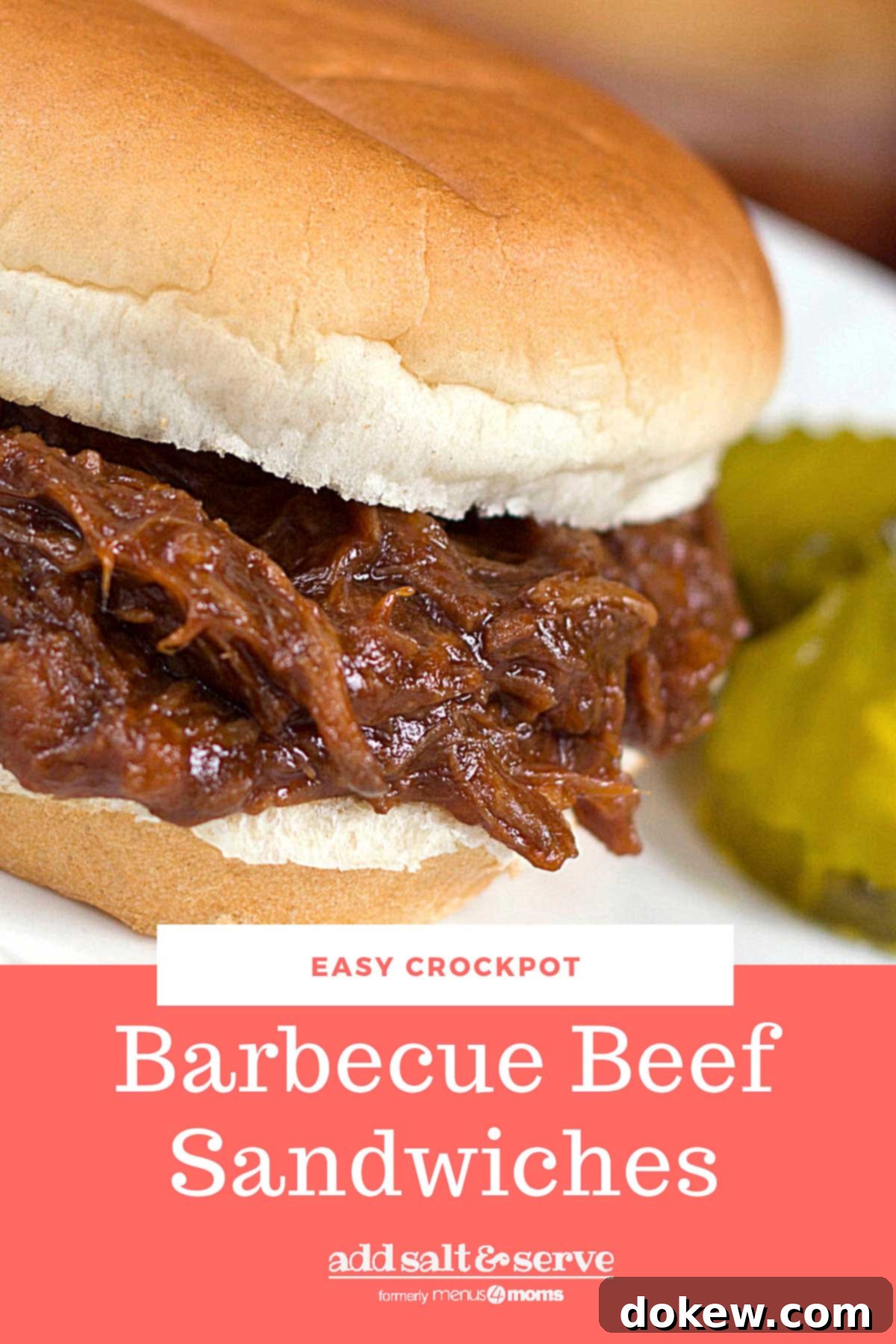 Set-It-and-Forget-It BBQ Beef Sandwiches 4 Barbecue Roast Beef Sandwich garnished with two pickle slices.