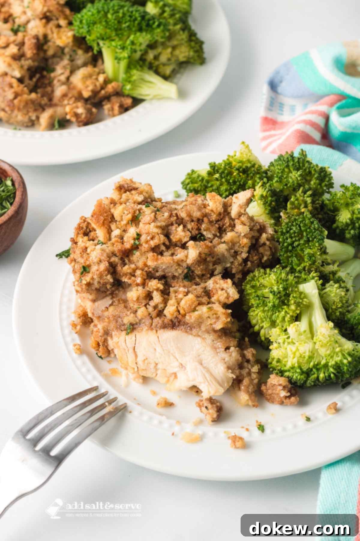 Effortless Slow Cooker Chicken and Stuffing 7 Two plates of Crockpot Chicken and Stuffing served with a side of fresh broccoli.