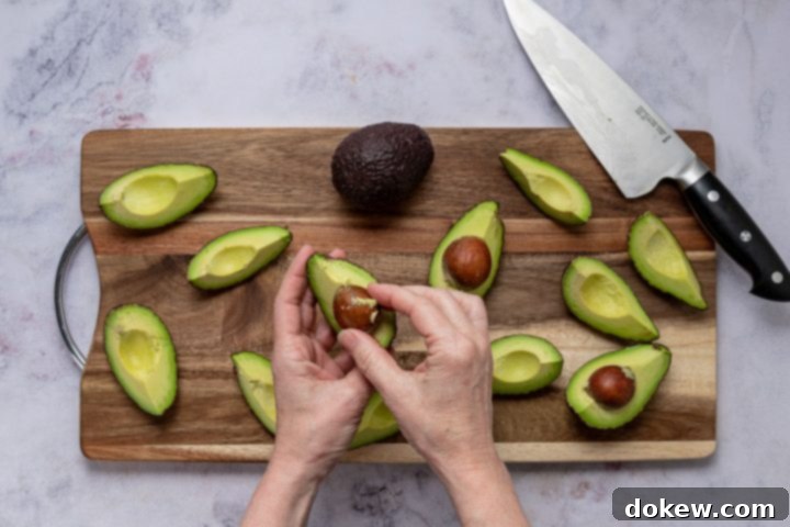 Foolproof Homemade Guacamole Guide 5 peeling avocado quarters
