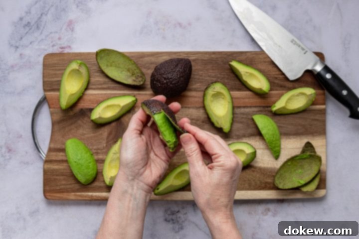 Foolproof Homemade Guacamole Guide 6 Several quartered and pitted avocados on a cutting board