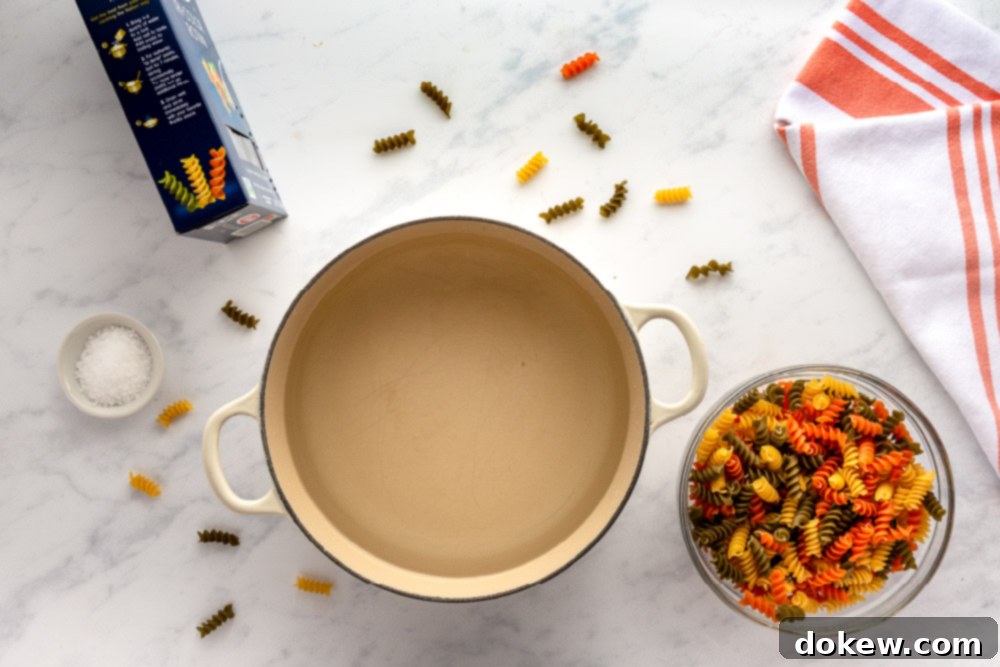 Thai Sesame Noodle Bowl 5 pan with water and a bowl of rotini