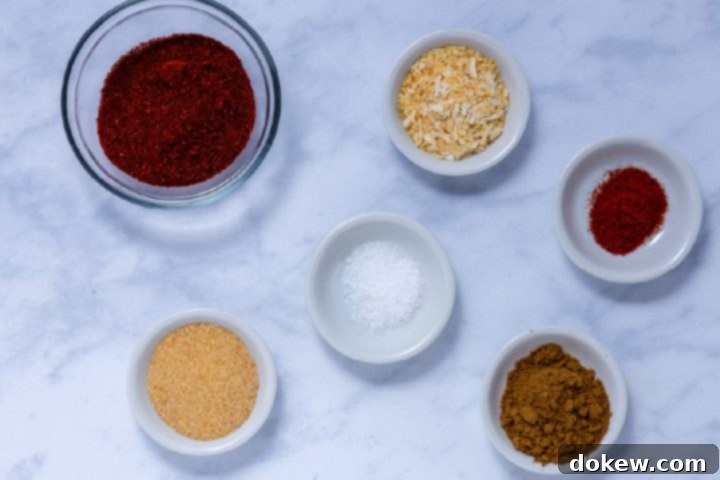 Legendary Terlingua Chili 4 Individual bowls of various spices, including chili powder, cumin, cayenne pepper, garlic powder, dried minced onion, and salt, meticulously arranged for the homemade Terlingua chili mix.