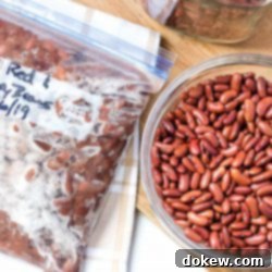 Cook and Freeze Dried Beans 2 Overhead shot of bowl of dried kidney beans with a strainer and a bowl of great northern beans on a cutting board