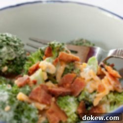 Fresh & Creamy Broccoli Crunch 2 Broccoli, shredded cheddar cheese, bacon bits, and mayonnaise in a bowl with a fork.