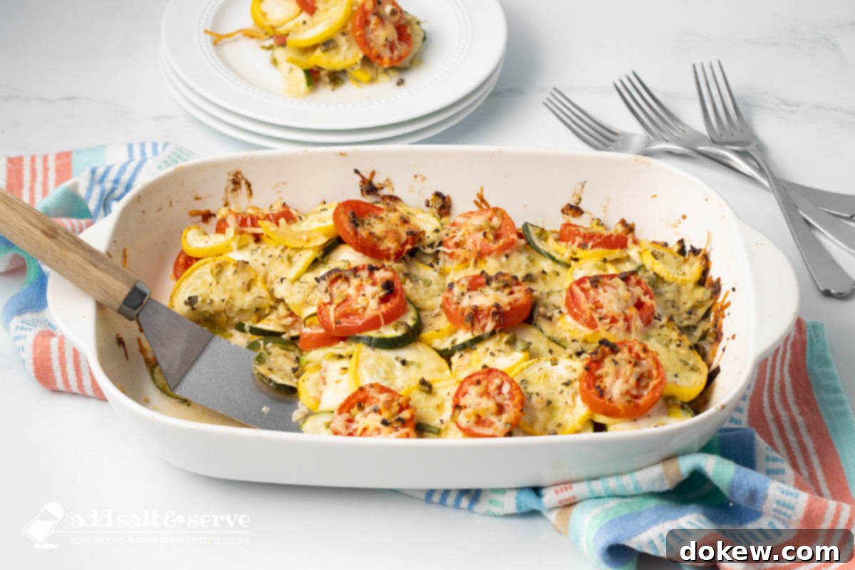 Rustic Tomato and Squash Bake 2 Baked layered casserole of yellow squash, zucchini, and tomatoes with herbs and cheese in a baking dish, ready to be served.