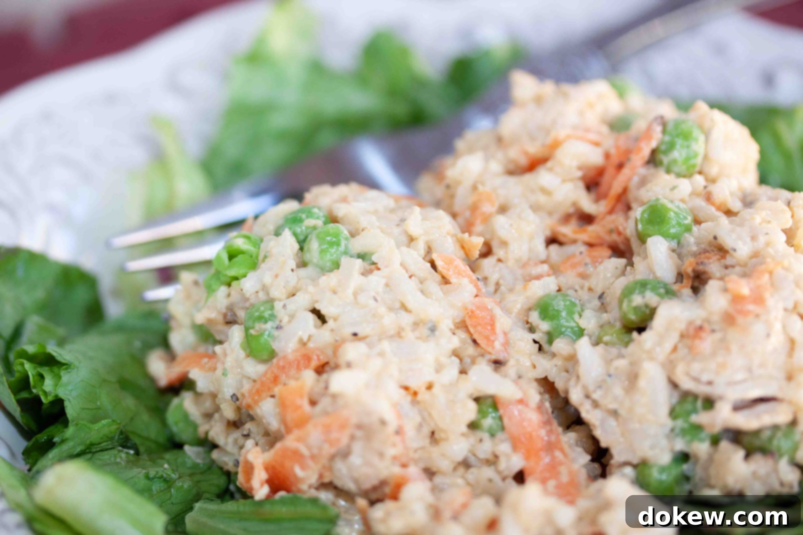 veggie-rice-salad-with-chicken-insta-min Cold rice salad with chicken and peas on a bed of lettuce.