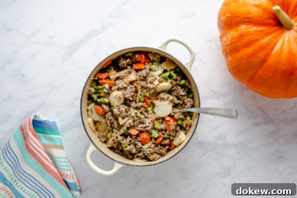 The Great Pumpkin Supper 4 Ground beef and rice mixture simmering in a pot for pumpkin filling