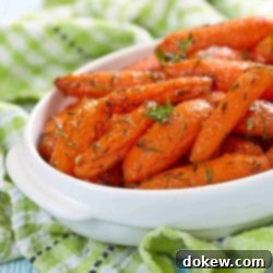 Golden Glazed Baby Carrots 2 Glazed carrots garnished with parsley in a serving bowl.