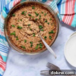 Caramelized French Onion Rice 3 French Onion Rice garnished with parsley in a casserole dish with a serving spoon.