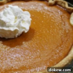 Grandma's Signature Pumpkin Pie 2 Baked pumpkin pie garnished with whipped cream