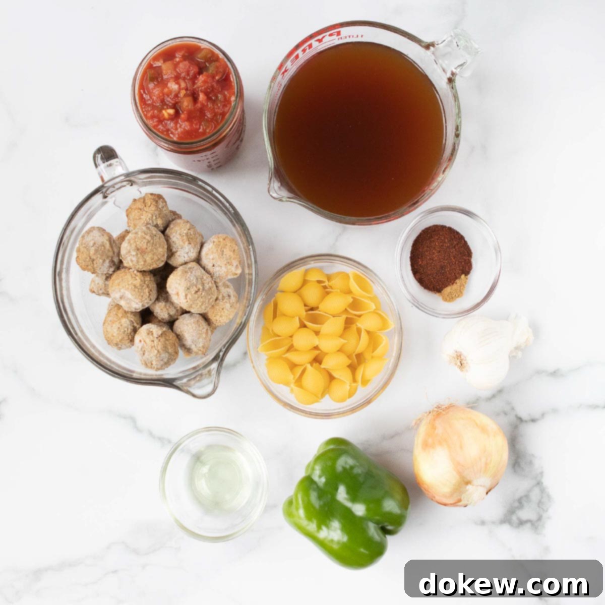 Crockpot Albondigas Soup (Mexican Meatball Soup) Overhead shot of ingredients: meatballs, salsa, beef broth, spices, shell pasta, olive oil, garlic bulb, onion, green bell pepper