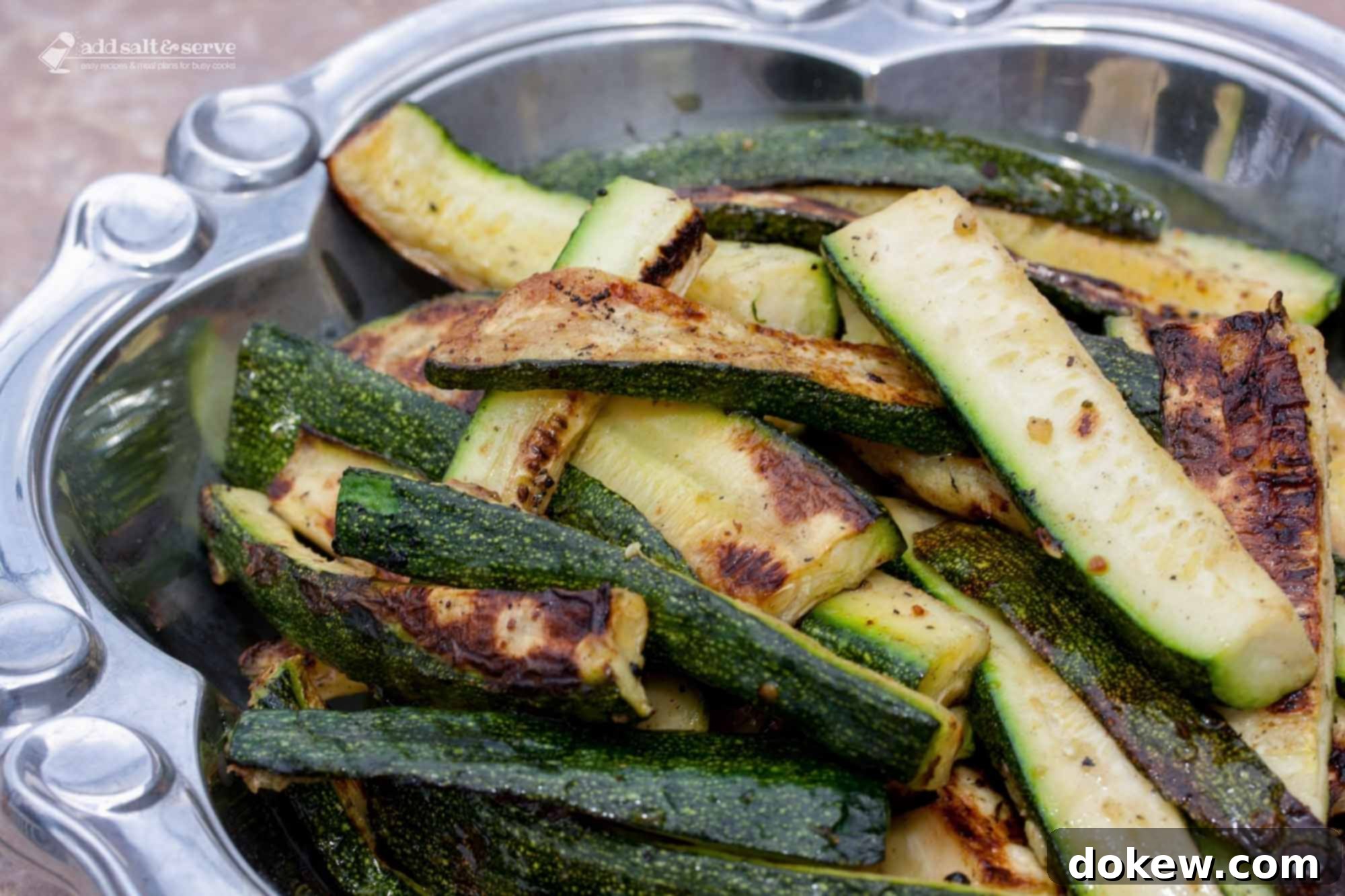 Chargrilled Zucchini Perfection 2 Perfectly grilled zucchini slices arranged in a rustic serving bowl, ready to be enjoyed.
