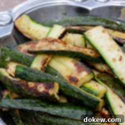 Chargrilled Zucchini Perfection 4 Grilled, sliced zucchini in a pewter serving bowl.