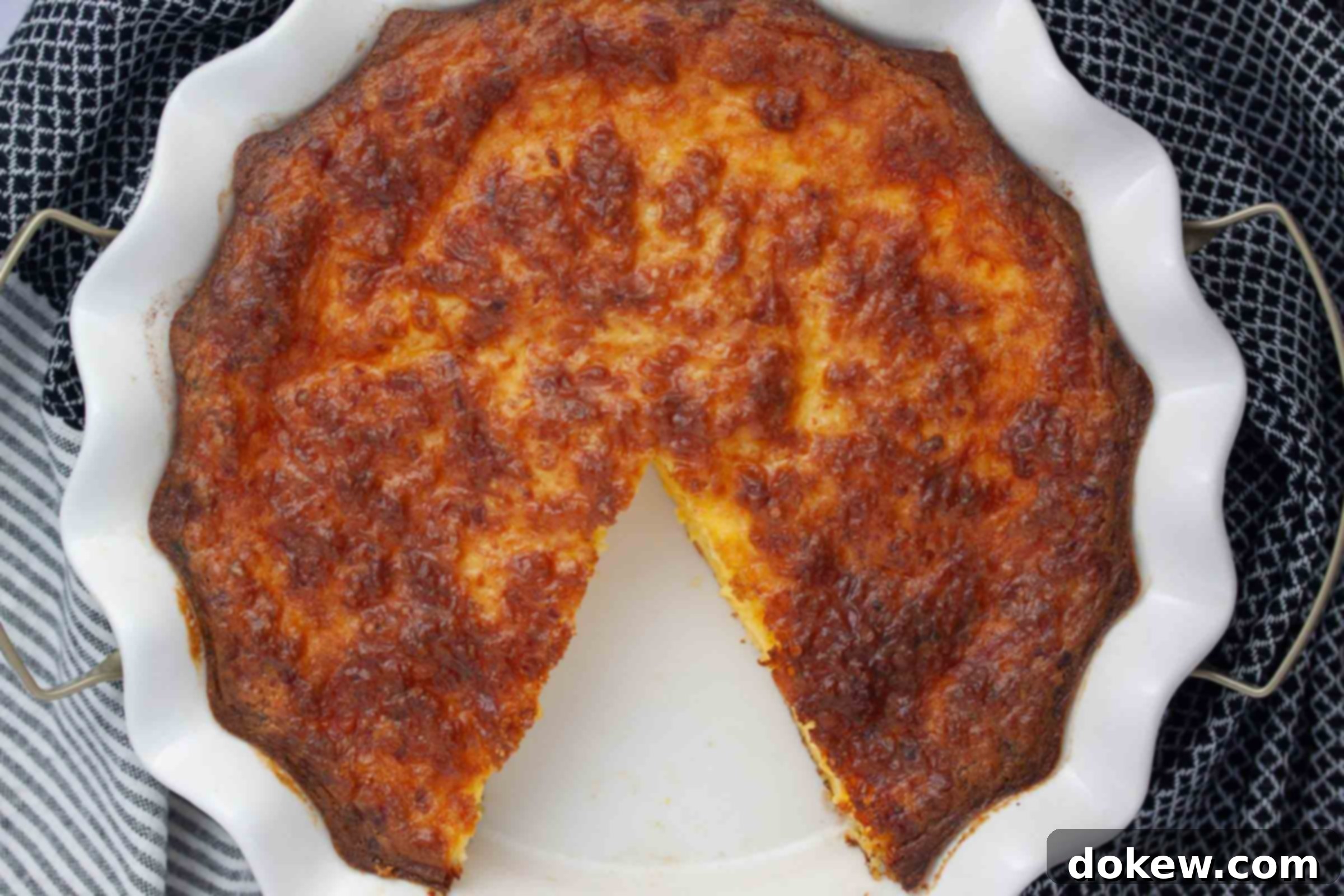 Protein-Rich Crustless Cottage Cheese Bake 5 Overhead view of a slice of crustless quiche with one piece removed.