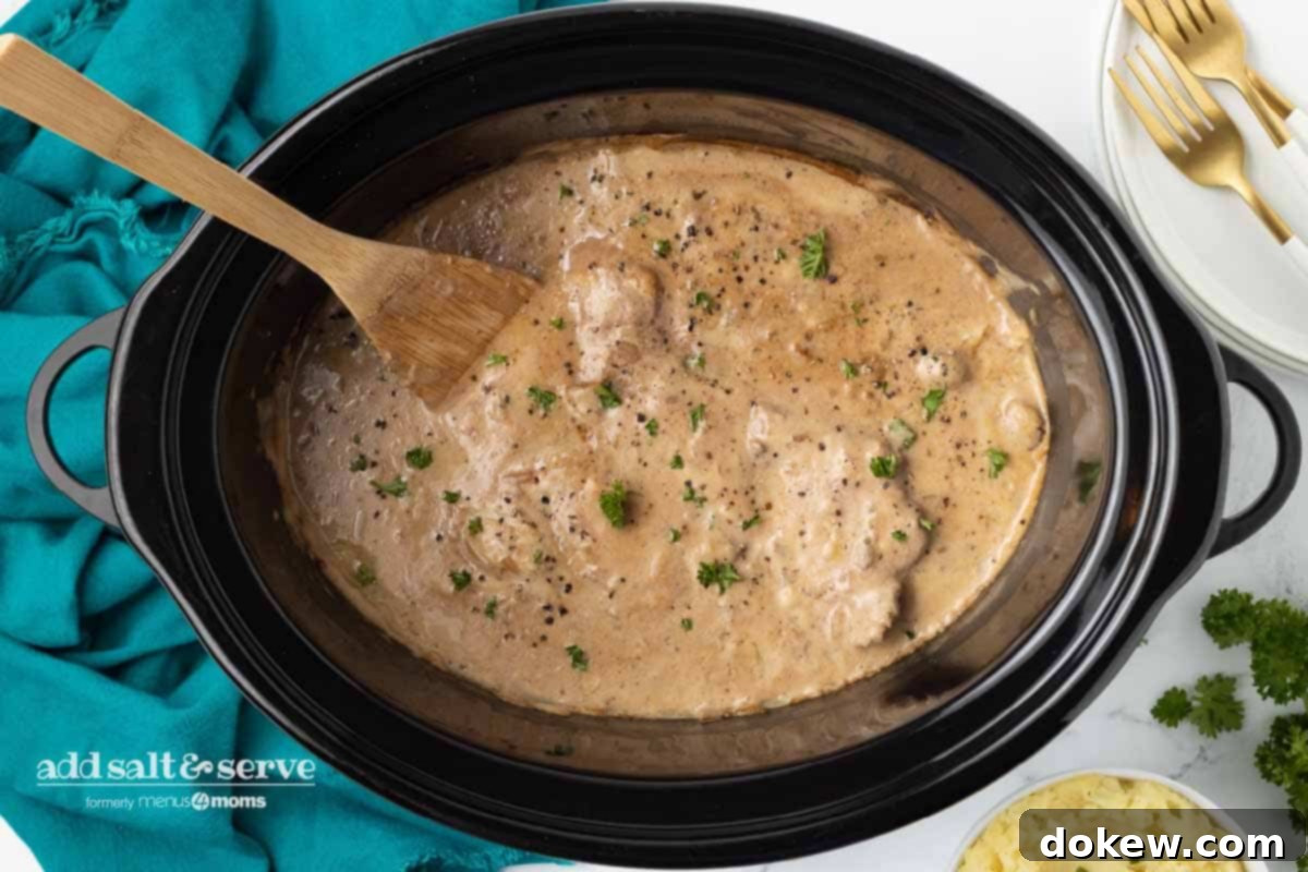 Crock Pot Cube Steak with Creamy Mushroom Sauce 6 Cooked cube steak with mushroom soup gravy after cooking in a crock pot, ready to be served.