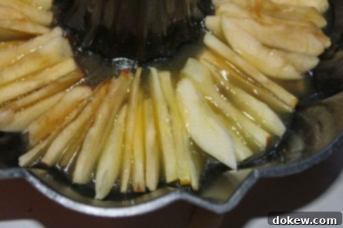 Golden Caramel Apple Bundt 12 Peeled and sliced apples placed in a butter brown sugar mixture in a bundt pan.