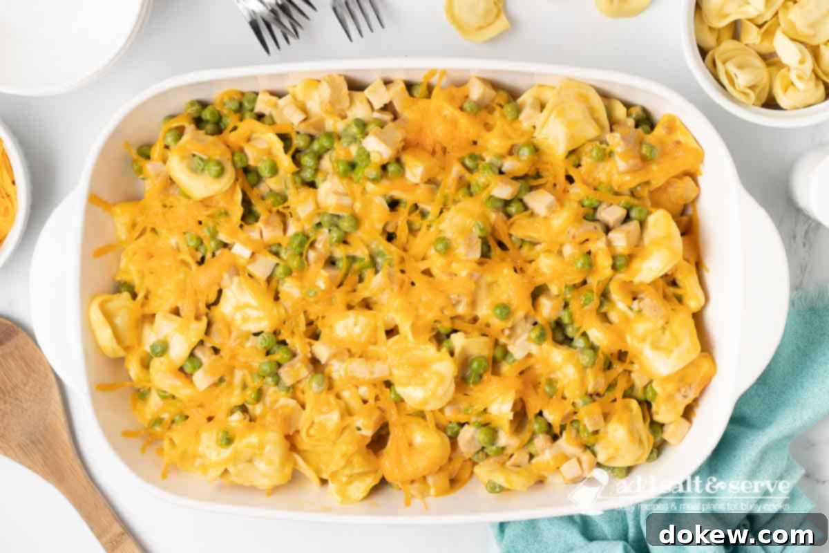 Golden Turkey Tortellini Bake 8 The finished Leftover Turkey Tortellini Casserole, baked to a golden-brown perfection with melted, bubbly cheese on top, ready to be served.