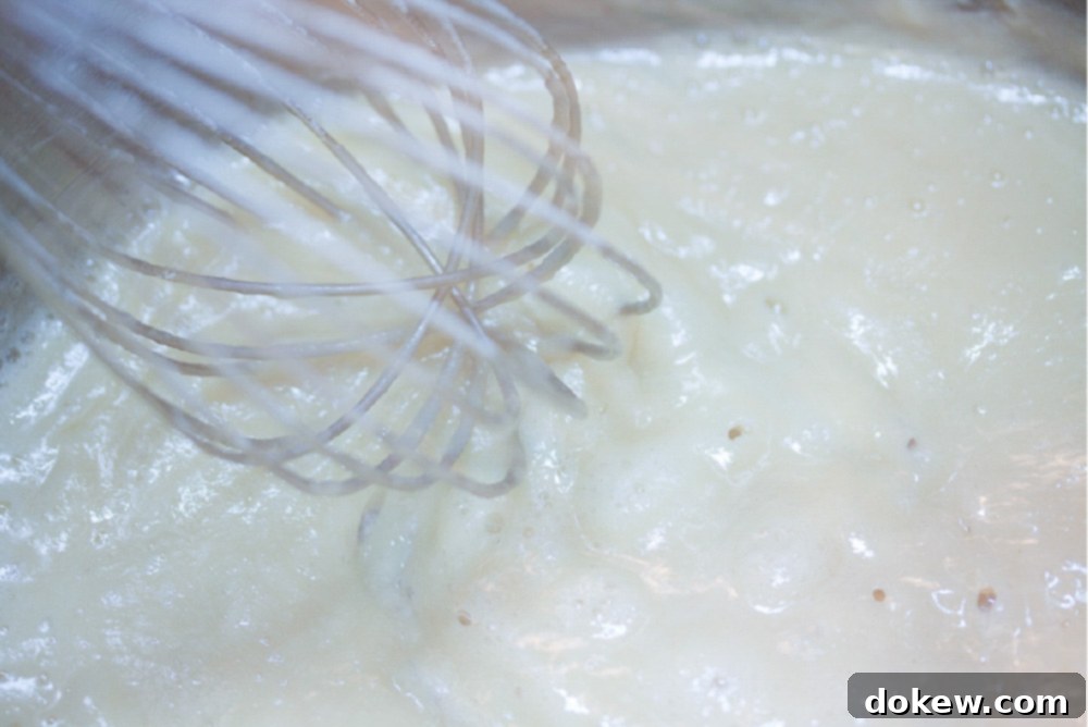Loaded Baked Potato Soup 3 A whisk stirring butter and flour in a saucepan to create a roux for baked potato soup.