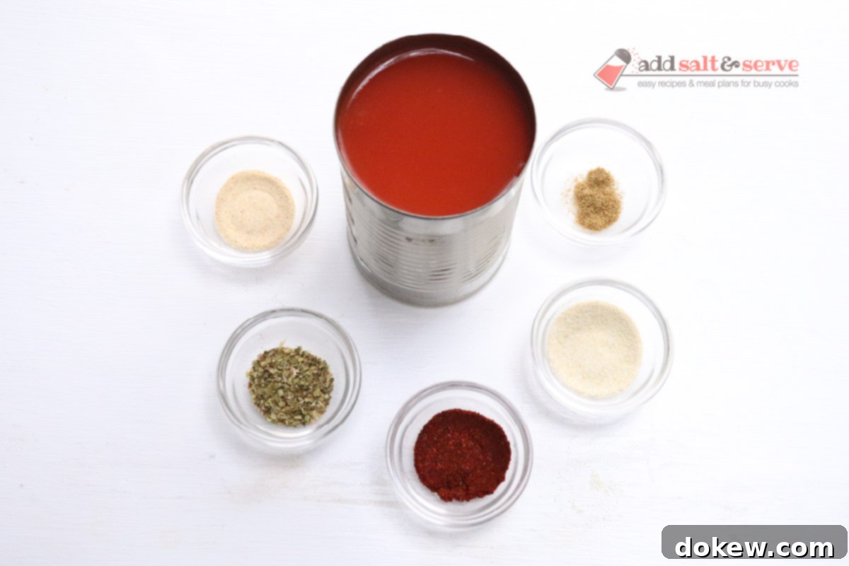 Ingredients for mojado sauce, including tomato sauce, chili powder, cumin, oregano, and garlic powder, arranged in small glass bowls.