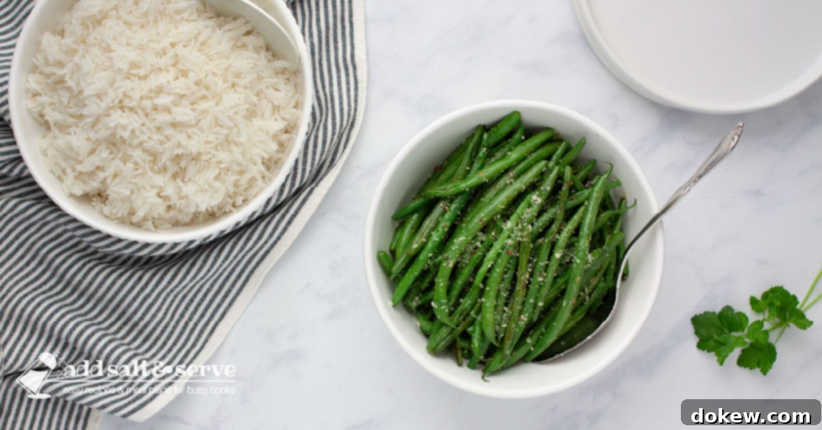 Green Beans Seasoned with Italian Dressing A serving bowl of cooked Seasoned Green Beans beside a serving bowl of white rice.