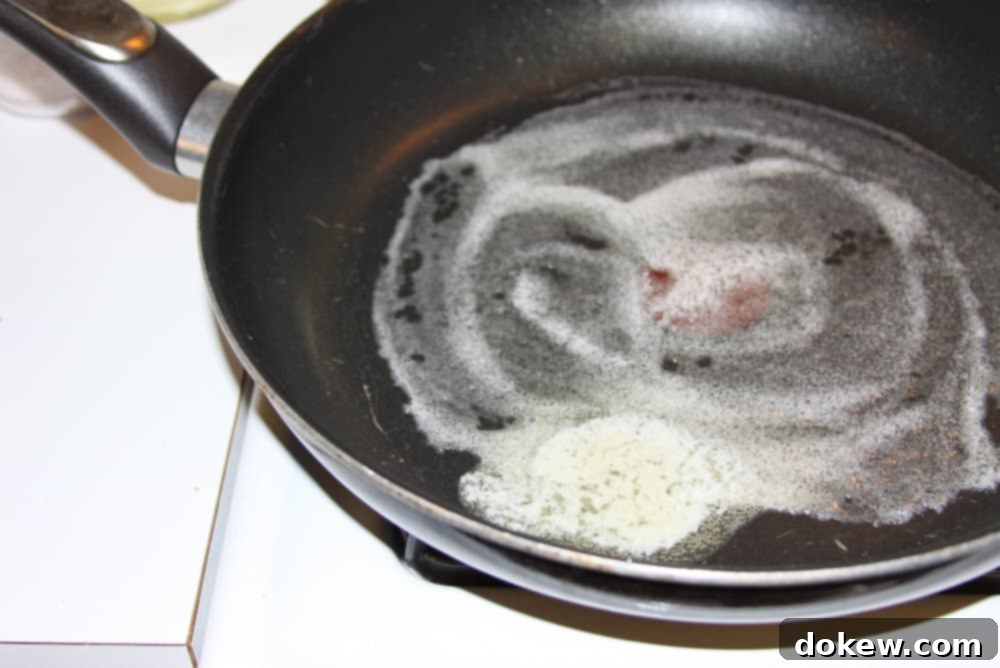 Green Beans Seasoned with Italian Dressing butter melting in a black frypan