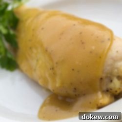 Sweet & Tangy Maple Dijon Chicken 2 White plate with chicken breast topped with a Dijon sauce.