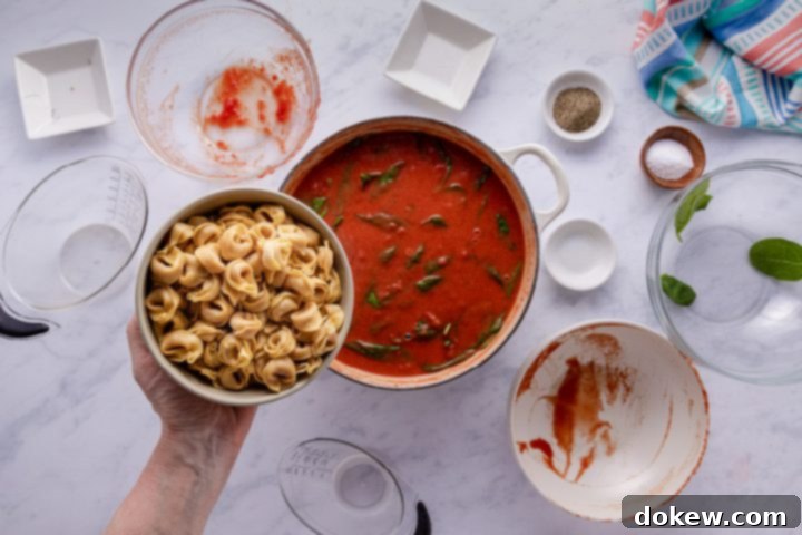 Effortless 15-Minute Tomato Spinach Tortellini Delight 7 Adding tortellini to Tomato Spinach Tortellini Soup
