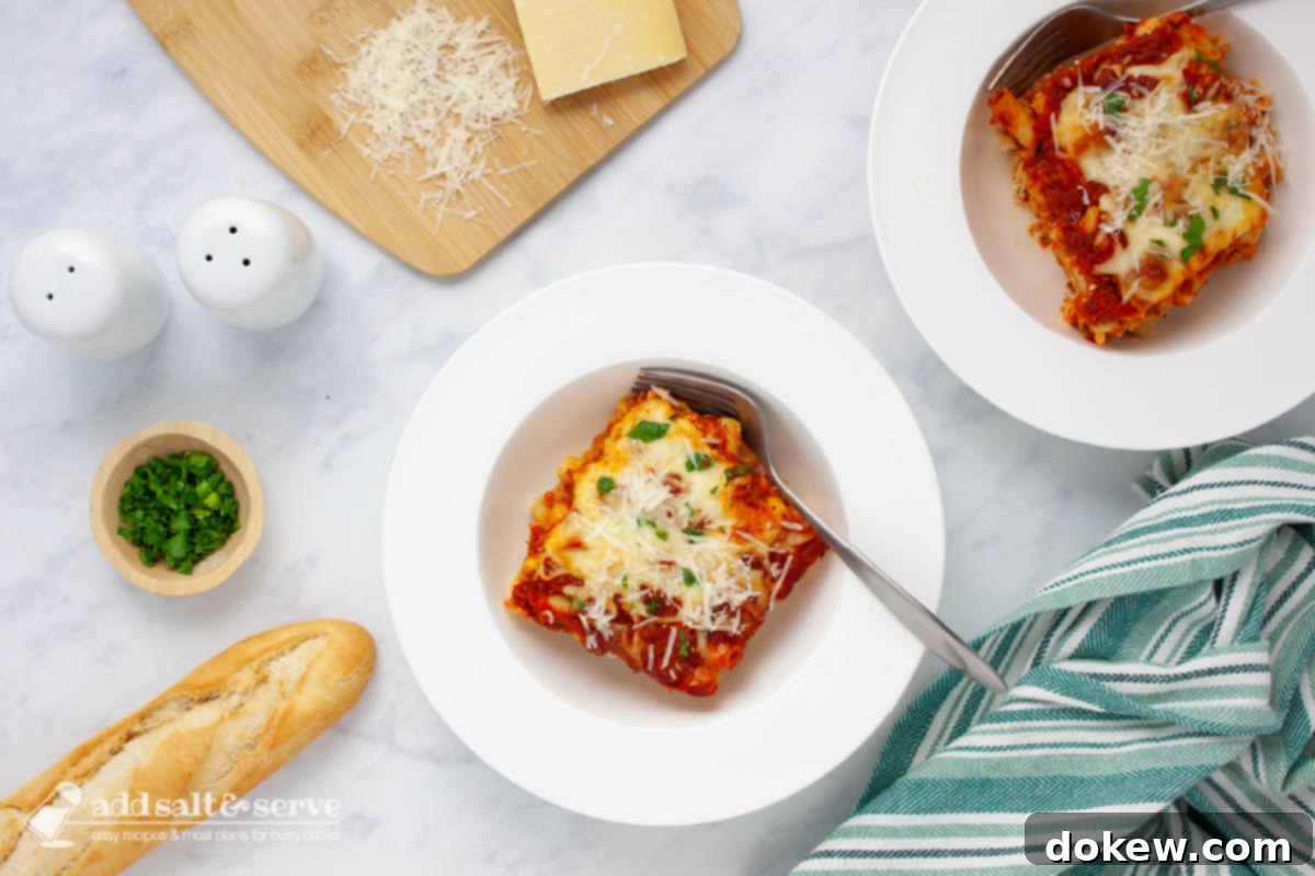 Classic Cheesy Meatless Baked Ziti 10 A inviting bowl of cheesy meatless baked ziti, beautifully garnished with fresh green parsley and a sprinkle of grated Parmesan cheese, ready to be enjoyed.