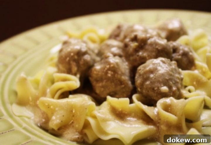 Swedish Meatball Recipe Yellow bowl with egg noodles covered in meatballs with cream sauce