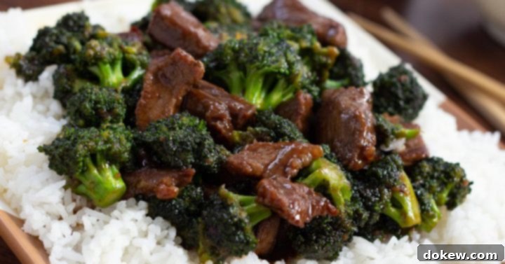 Repurposed Steak and Broccoli Stirfry 6 A plate of Beef and Broccoli stir fry with tender beef slices, vibrant broccoli, and glossy sauce, served over white rice with chopsticks on the side.