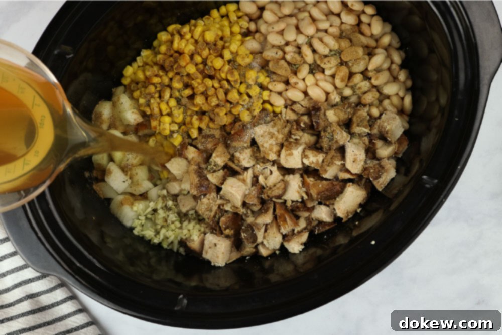 Effortless White Chicken Chili 5 All ingredients for white chicken chili combined in a slow cooker, ready for cooking.