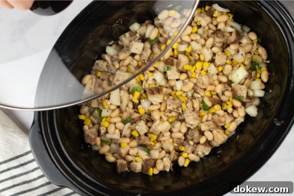 Effortless White Chicken Chili 6 White chicken chili simmering gently in a slow cooker.