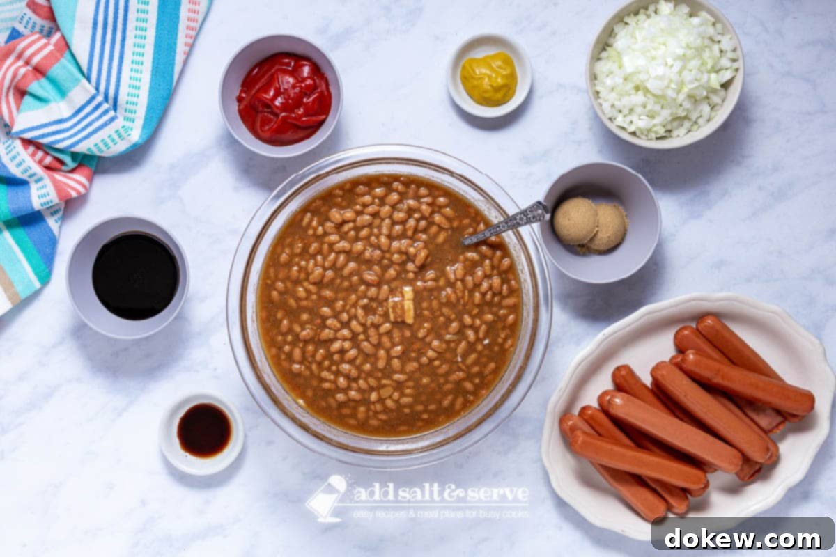 Hot Dog and Bean Bake 3 Overhead view of ingredients for baked franks and beans recipe, including hot dogs, beans, onion, and sauce components.