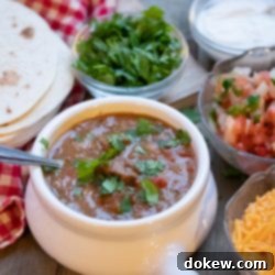 Easy Instant Pot Carne Guisada 3 A vibrant bowl of Instant Pot Carne Guisada (Mexican Beef Stew) with tender beef, rich gravy, and colorful garnishes, ready to be served.