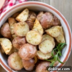 Crispy Garlic Roasted Red Potatoes 3 A close-up of a bowl filled with golden-brown, chopped roasted red potatoes, perfectly seasoned and ready to serve or use in potato salad.